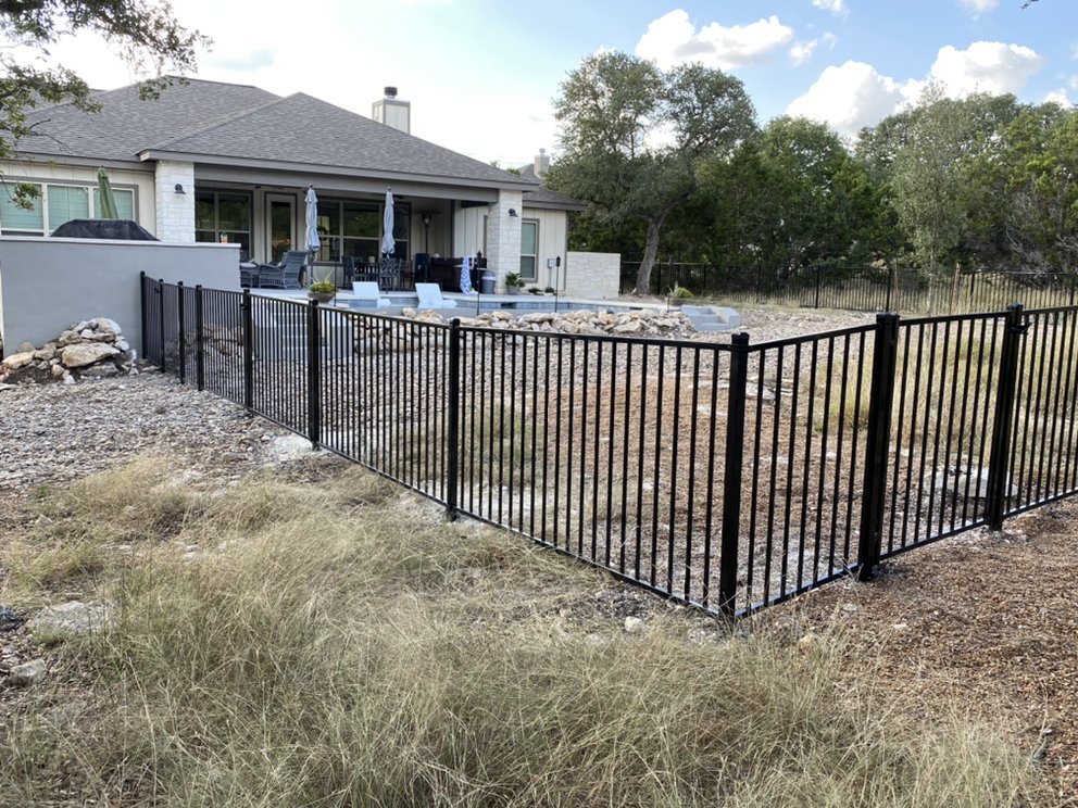 Wrought Iron Fence in the Backyard of a House with a Pool